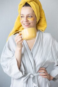 woman sipping coffee after treating her Rosacea
