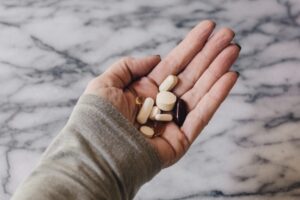 hand holding the top vitamins to take for wellness