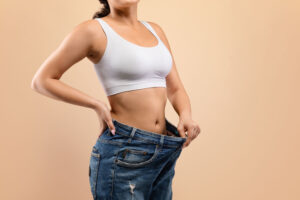 woman showing weight loss progress
