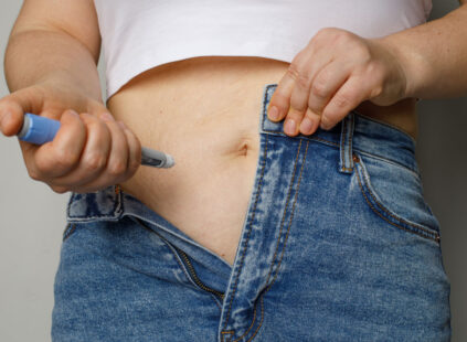 person injecting self with weight loss medication